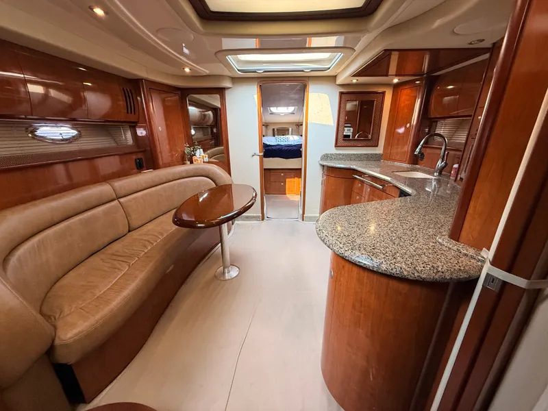 Slide: The Image of Interior of the 2005 Sea Ray 420 Sundancer with elegant kitchen and comfortable seating area. - 15