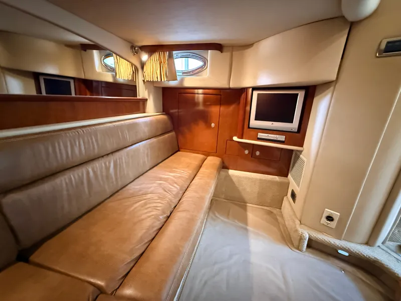 Slide: The Image of Interior of the 2005 Sea Ray 420 Sundancer with leather sofa and built-in TV. - 23