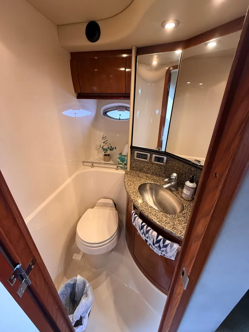 Slide: The Image of The image shows an elegant boat bathroom with a sink, toilet, and mirror. - 27