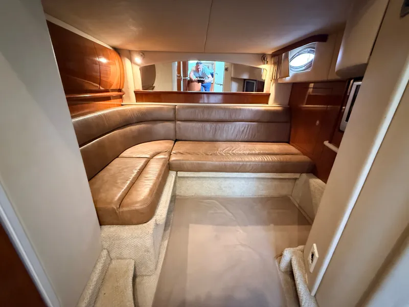 Slide: The Image of Interior of the 2005 Sea Ray 420 Sundancer with leather sofa and wooden walls. - 22
