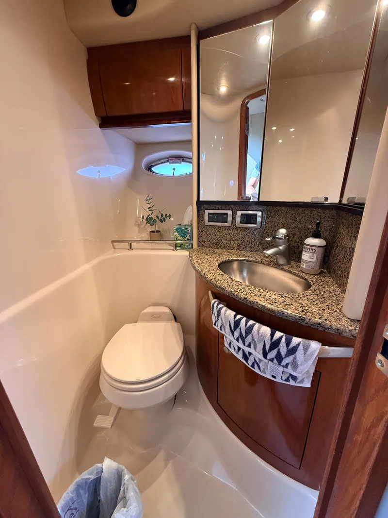 Slide: The Image of The image shows a sleek bathroom on a 2005 Sea Ray 420 Sundancer boat. - 19