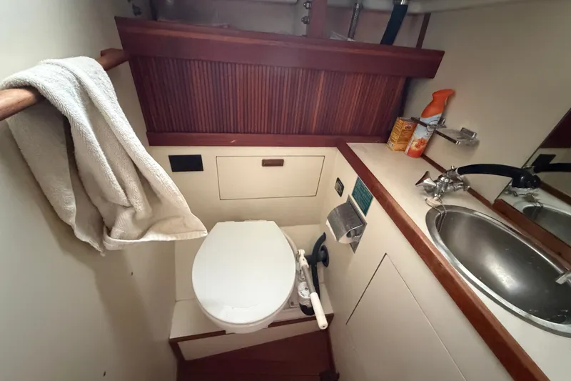 Slide: The Image of Compact bathroom in a 1990 Sabre 34 MK II yacht, featuring toilet and sink. - 60