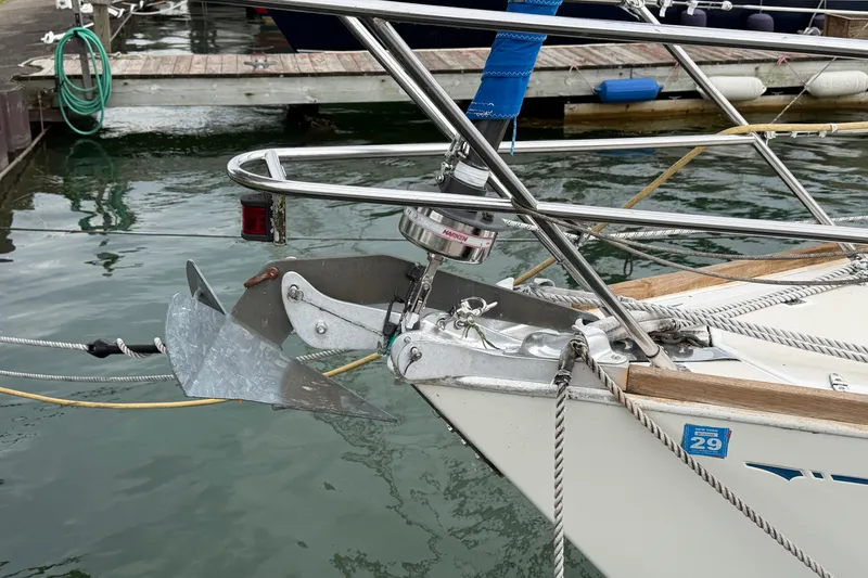 Slide: The Image of Bow of 1990 Sabre 34 MK II sailboat with anchor and dock background. - 4