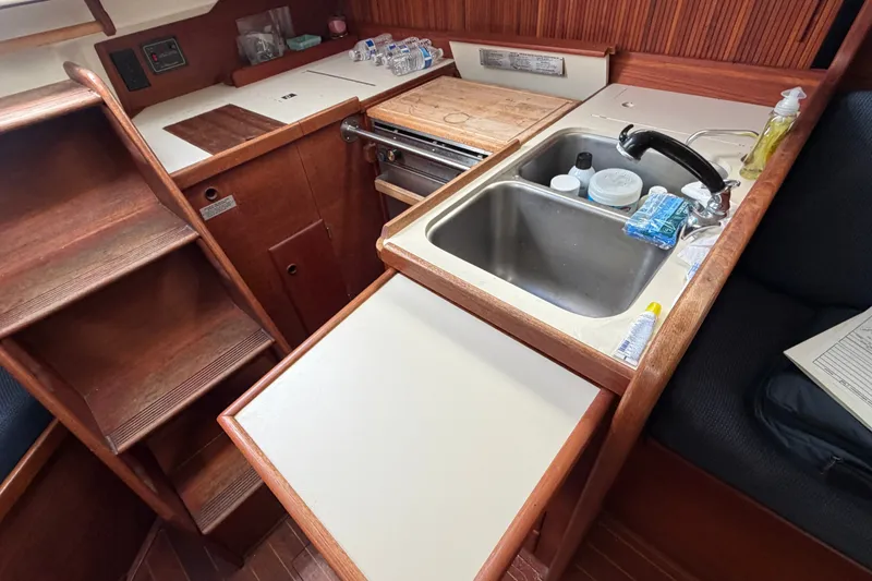 Slide: The Image of Compact galley kitchen in 1990 Sabre 34 MK II sailboat with sink and wooden cabinetry. - 31