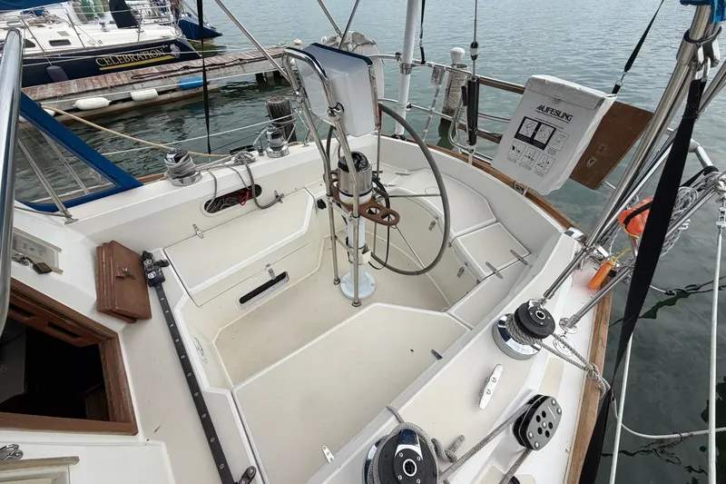 Slide: The Image of Cockpit of a 1990 Sabre 34 MK II sailboat, featuring steering wheel and winches. - 16