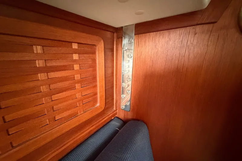Slide: The Image of Interior of 1990 Sabre 34 MK II yacht with wooden paneling and metal bracket. - 51