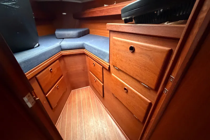 Slide: The Image of Cozy cabin interior of 1990 Sabre 34 MK II sailboat with wooden drawers and blue cushions. - 55