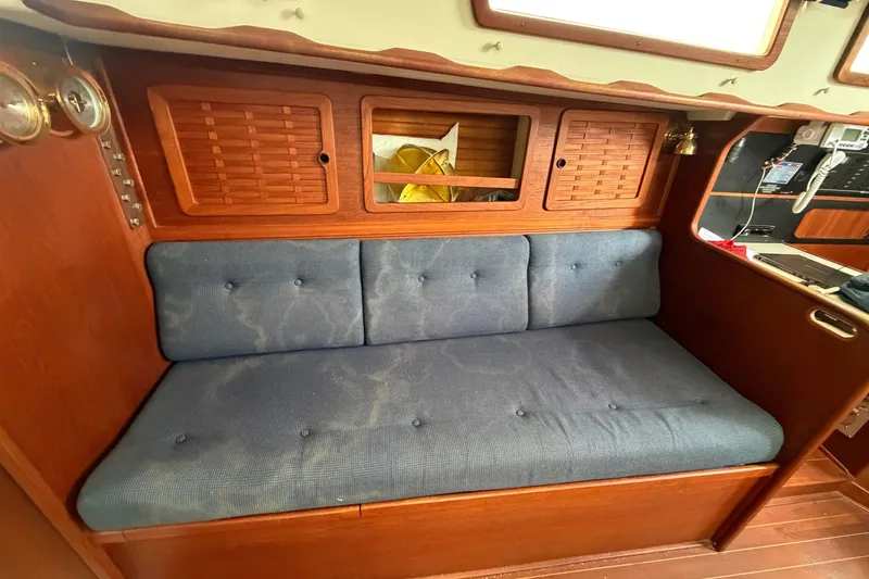 Slide: The Image of Interior of 1990 Sabre 34 MK II sailboat with blue cushioned seating. - 42