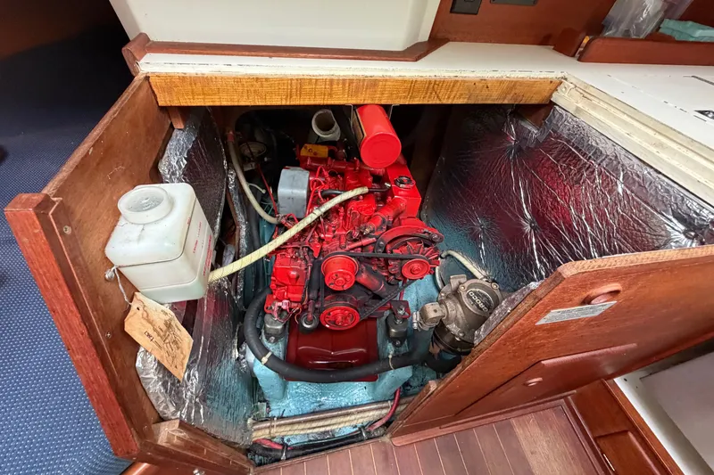 Slide: The Image of Engine compartment of a 1990 Sabre 34 MK II sailboat, featuring a red engine. - 64