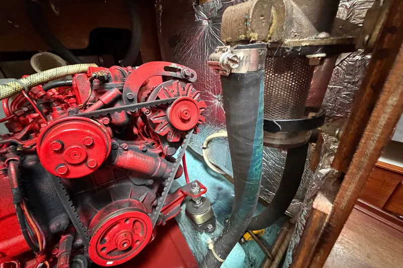Slide: The Image of Engine compartment of a 1990 Sabre 34 MK II sailboat, featuring red mechanical components. - 67