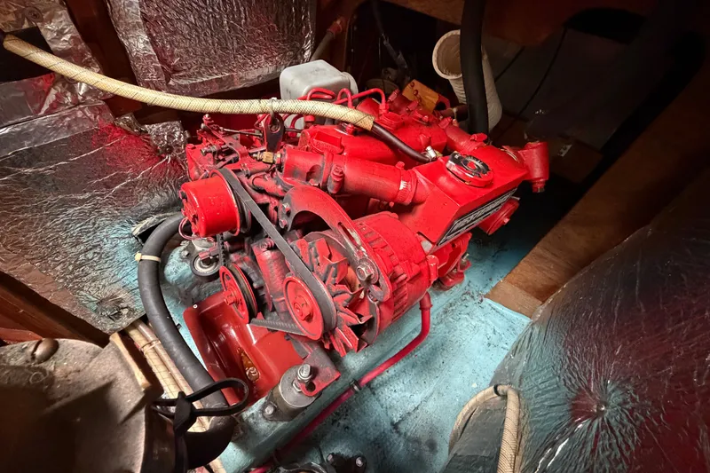 Slide: The Image of Red engine inside 1990 Sabre 34 MK II sailboat, surrounded by insulated compartment. - 66
