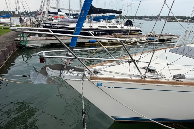 Slide: The Image of 1990 Sabre 34 MK II sailboat docked at marina, featuring anchor and rigging. - 5