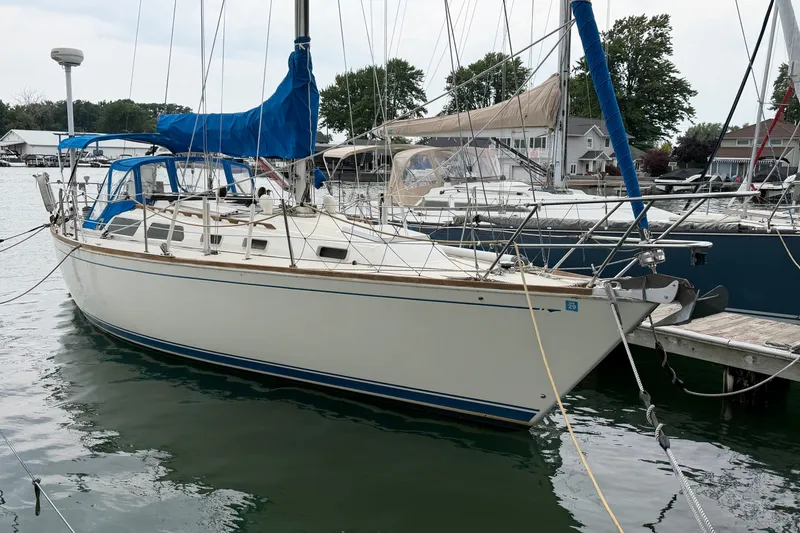 Slide: The Image of 1990 Sabre 34 MK II sailboat docked at marina with blue covers. - 3