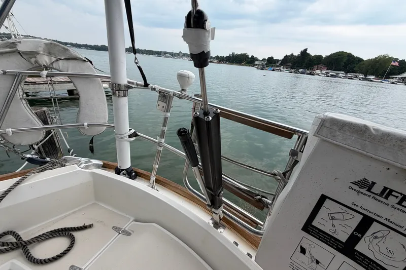 Slide: The Image of Sailboat deck view, Sabre 34 MK II, 1990, with safety equipment and scenic waterfront. - 17