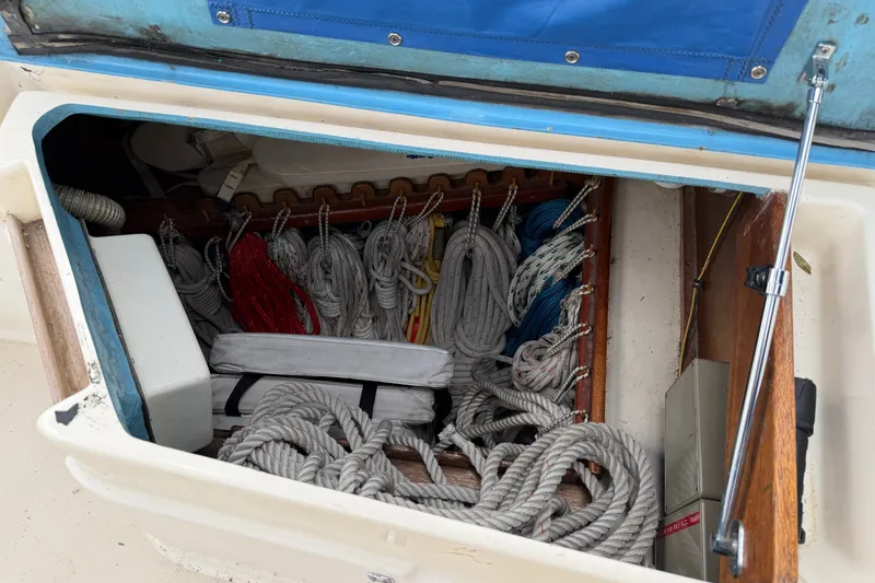 Slide: The Image of Storage compartment on a 1990 Sabre 34 MK II sailboat, filled with neatly coiled ropes. - 22