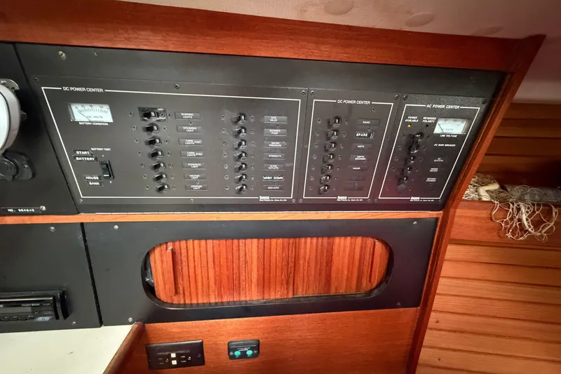 Slide: The Image of Electrical panel of a 1990 Sabre 34 MK II sailboat, featuring DC and AC power controls. - 40