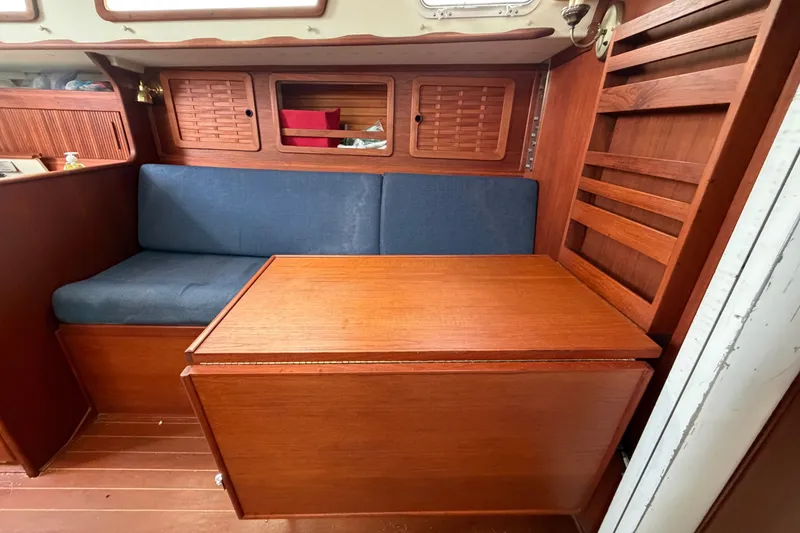 Slide: The Image of Interior of 1990 Sabre 34 MK II sailboat with wooden table and blue seating. - 46