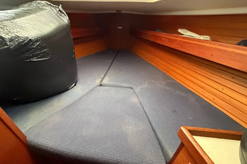 Slide: The Image of Interior cabin of 1990 Sabre 34 MK II sailboat with blue cushions and wooden paneling. - 56