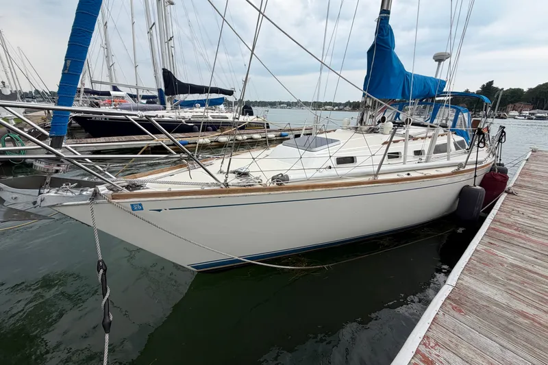 Slide: The Image of 1990 Sabre 34 MK II sailboat docked at marina, featuring blue sail covers. - 8