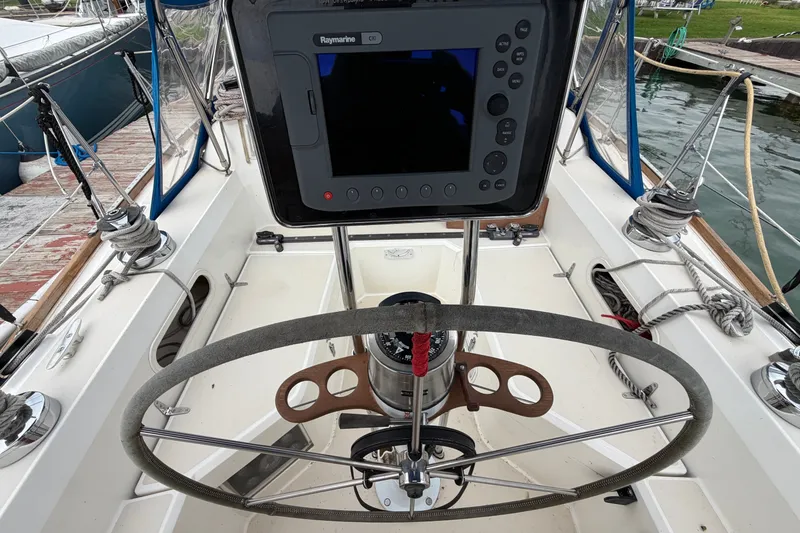 Slide: The Image of Cockpit of 1990 Sabre 34 MK II sailboat with steering wheel and navigation system. - 18
