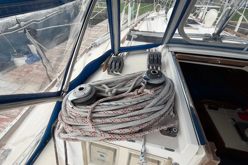 Slide: The Image of Cockpit view of a 1990 Sabre 34 MK II sailboat with coiled ropes and winches. - 25