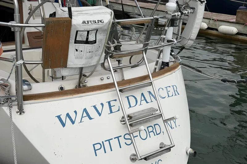Slide: The Image of Sailboat "Wave Dancer" docked, featuring a 1990 Sabre 34 MK II model in Pittsford, NY. - 14