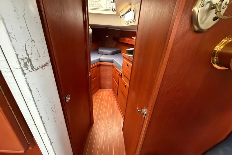 Slide: The Image of Interior of 1990 Sabre 34 MK II sailboat with wooden cabinetry and cozy sleeping area. - 49