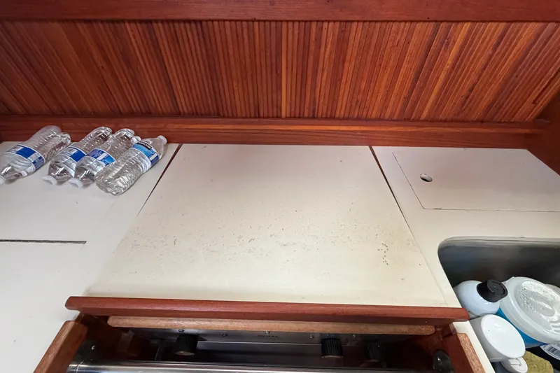 Slide: The Image of Interior of 1990 Sabre 34 MK II sailboat galley with water bottles and sink. - 33