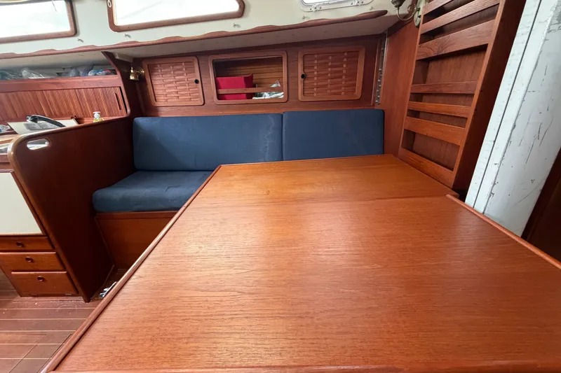 Slide: The Image of Interior of 1990 Sabre 34 MK II sailboat with wooden table and blue seating. - 47