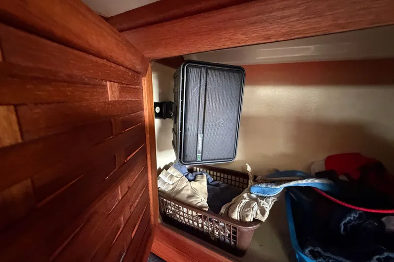 Slide: The Image of Storage compartment in a 1990 Sabre 34 MK II yacht with speaker and baskets. - 44