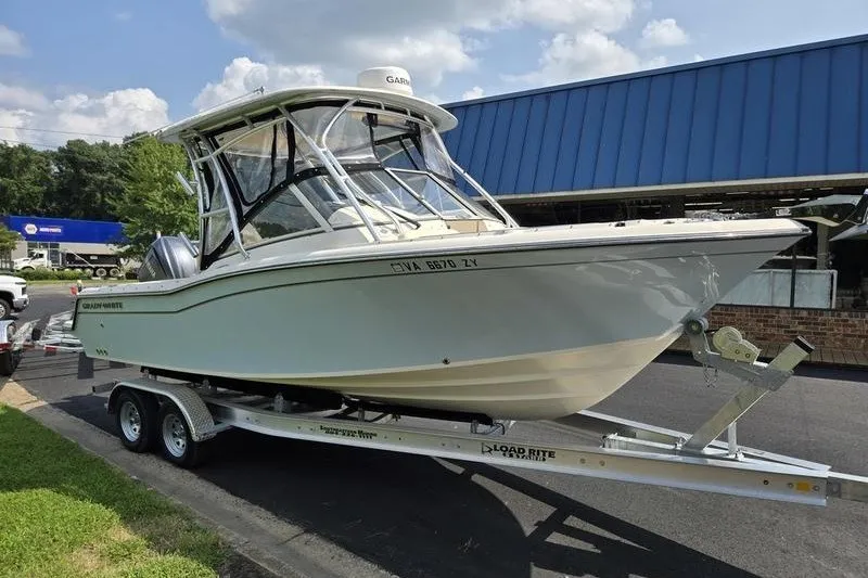 Slide: The Image of 2022 Grady-White Freedom 235 boat on trailer, parked outdoors. - 18