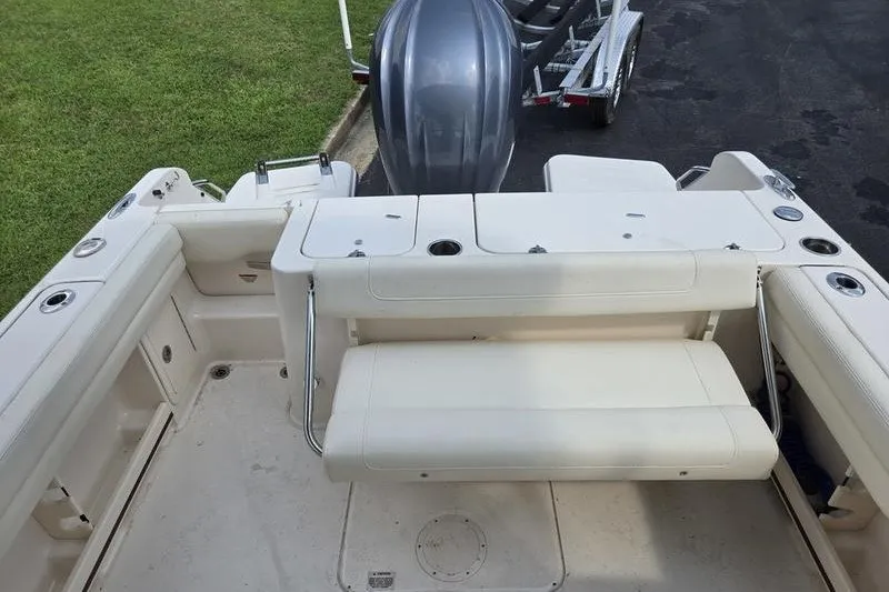 Slide: The Image of 2022 Grady-White Freedom 235 boat interior with seating and motor view. - 14
