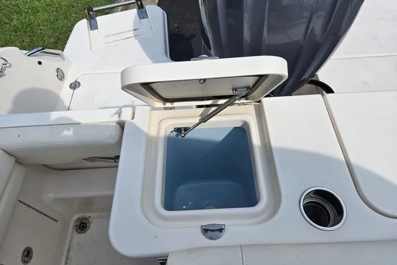 Slide: The Image of 2022 Grady-White Freedom 235 boat with open storage compartment. - 15