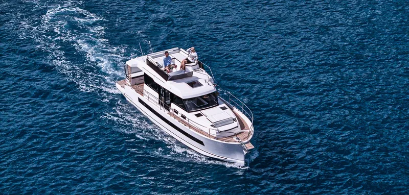 Slide: The Image of 2025 Northman 1300 yacht cruising on open blue water. - 2