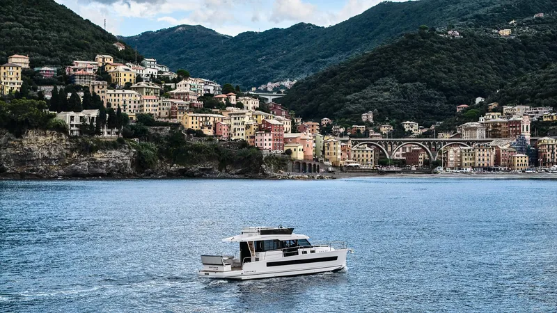 Slide: The Image of Modern Northman 1300 yacht cruising near colorful coastal town, 2025 model. - 13