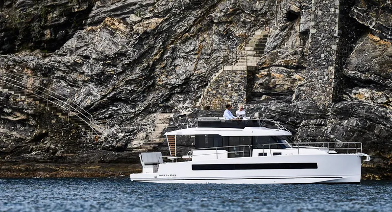 Slide: The Image of 2025 Northman 1300 yacht cruising near rocky cliffs. - 17