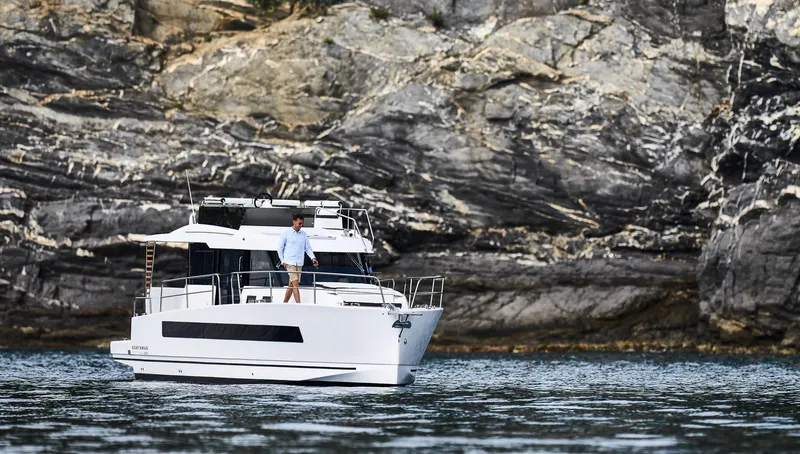 Slide: The Image of Man on Northman 1300 yacht near rocky shoreline, 2025 model. - 14