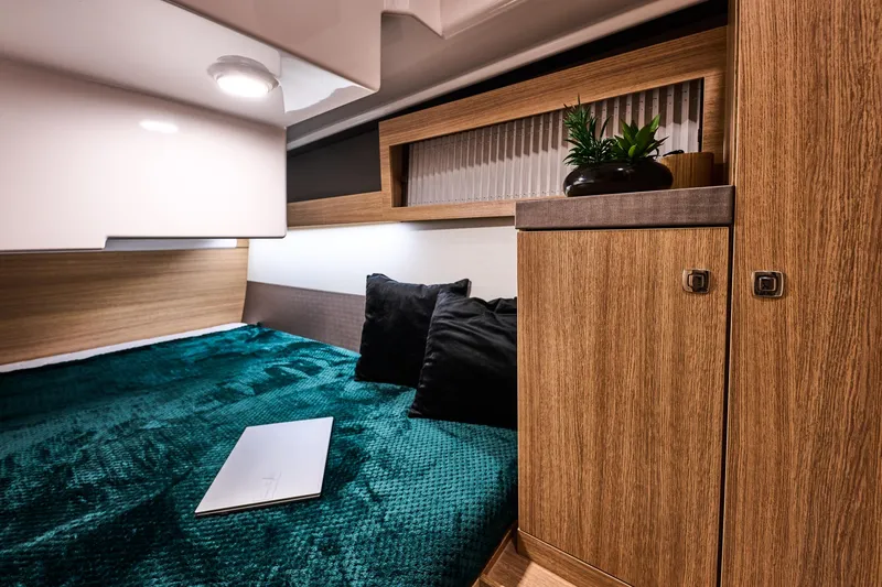 Slide: The Image of Interior of Northman 1300, 2026, featuring bed and wooden cabinets. - 49