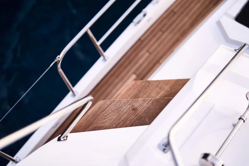 Slide: The Image of Deck view of 2025 Northman 1300 yacht with wooden flooring and metal railings. - 31