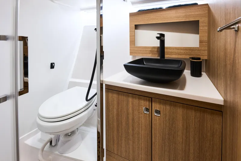 Slide: The Image of Modern bathroom in 2025 Northman 1300 yacht with sleek black sink and wooden cabinetry. - 46