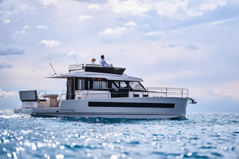 Slide: The Image of 2025 Northman 1300 yacht cruising on open water under a partly cloudy sky. - 19