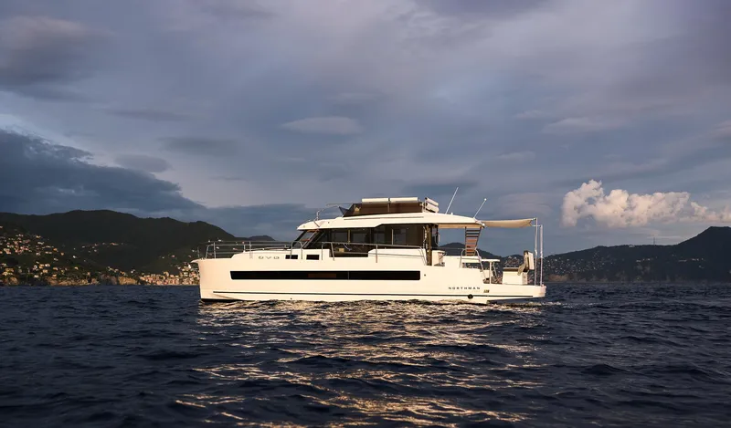 Slide: The Image of 2025 Northman 1300 yacht cruising on open water at sunset. - 8