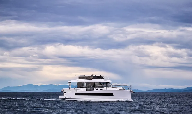 Slide: The Image of Modern Northman 1300 yacht cruising on open sea under cloudy sky, 2025 model. - 10
