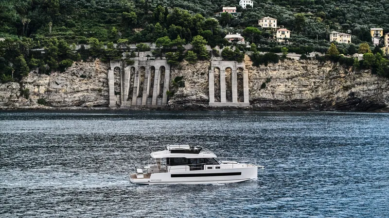 Slide: The Image of Modern Northman 1300 yacht cruising near scenic cliffs, 2025 model. - 12