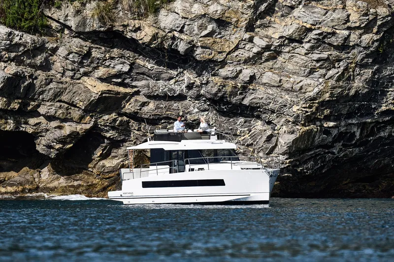 Slide: The Image of 2025 Northman 1300 yacht cruising near rocky cliffs. - 18