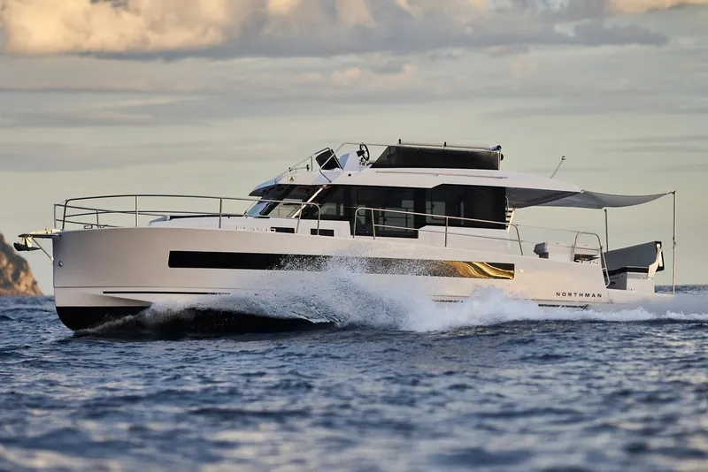 The Image of 2025 Northman 1300 yacht cruising on open water under a cloudy sky. - 0