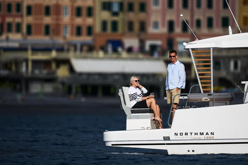 Slide: The Image of Couple enjoying leisure time on a 2025 Northman 1300 yacht near a coastal town. - 25