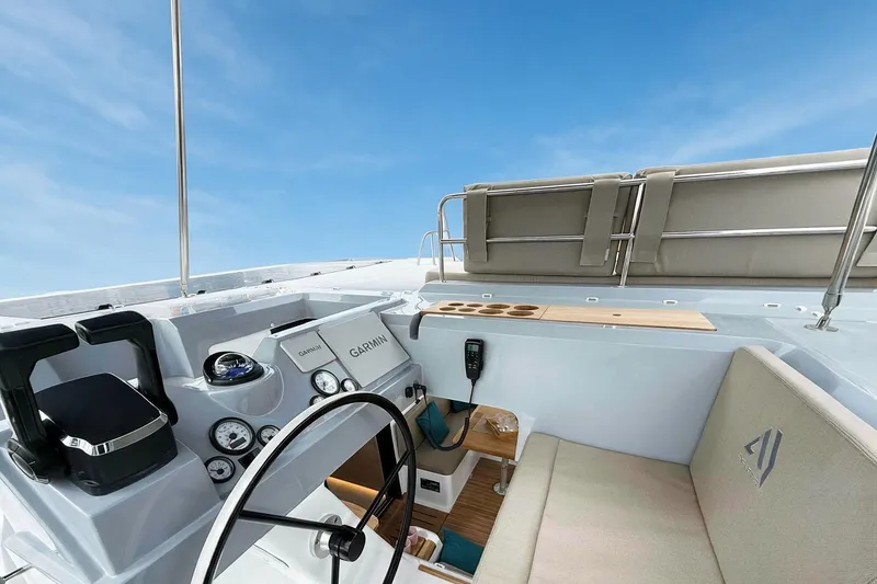 Slide: The Image of Cockpit of 2026 Aventura 37 Explorer Trawler with Garmin navigation, under clear blue sky. - 36