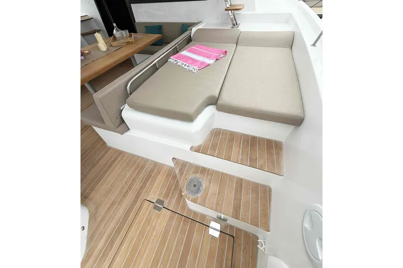 Slide: The Image of 2026 Aventura 37 Explorer Trawler interior with beige seating and wooden flooring. - 6