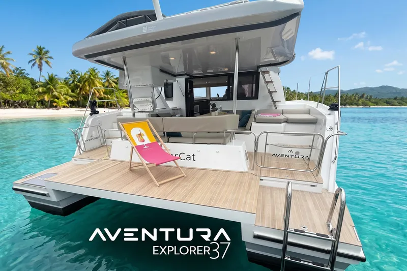 Slide: The Image of Aventura 37 Explorer Trawler 2026 docked near tropical beach with clear blue water. - 1